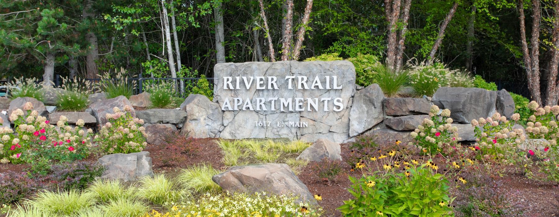 a stone sign in a garden