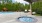 a swimming pool with a covered patio
