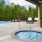 a swimming pool with a covered patio