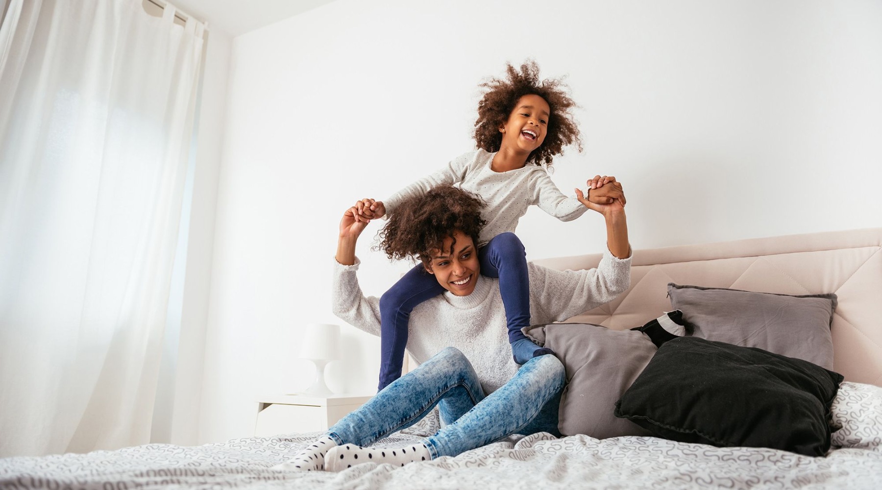 woman and girl on a bed